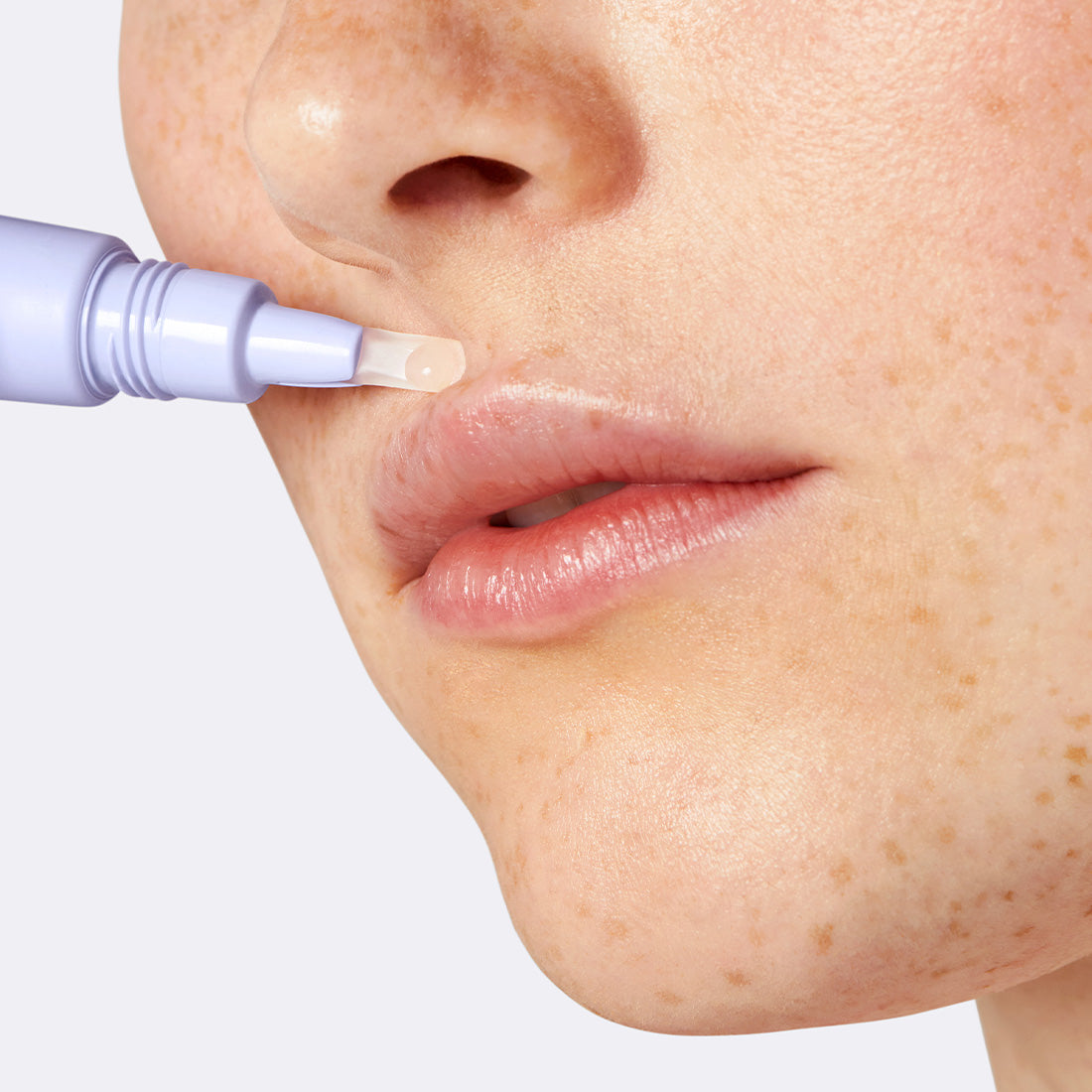 Flamingo Calming Serum being applied to the upper lip area